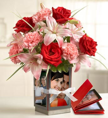 roses, lilies, carnations in metallic vase